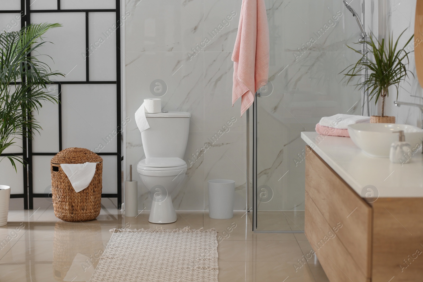 Photo of Interior of modern bathroom with toilet bowl