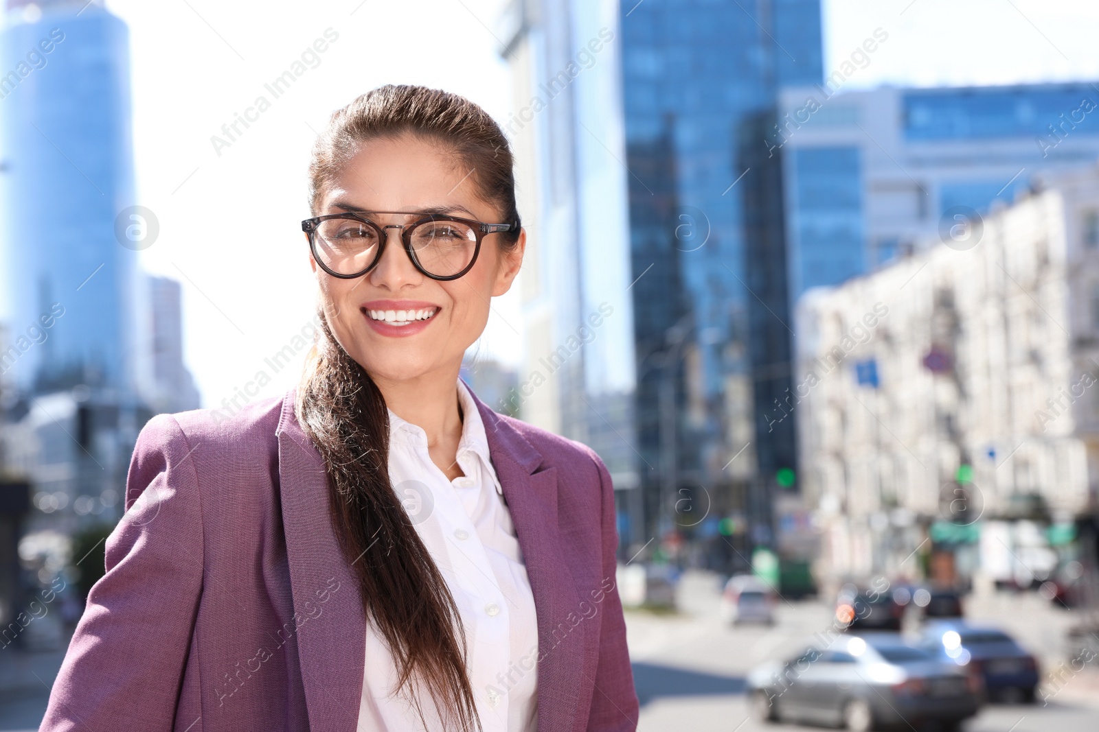 Photo of Beautiful confident businesswoman on city street. Space for text