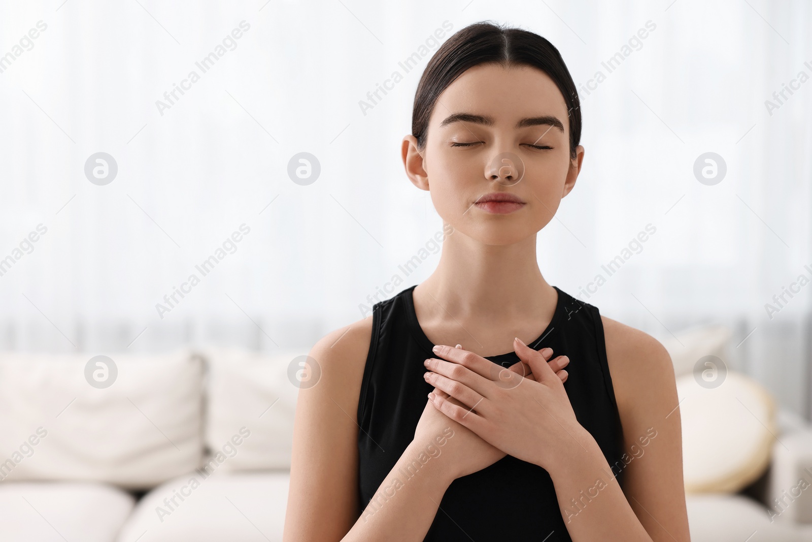 Photo of Beautiful girl meditating at home. Practicing yoga