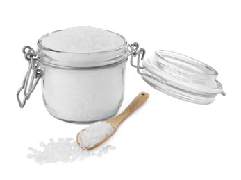 Photo of Glass jar and wooden spoon of natural sea salt isolated on white