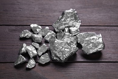 Photo of Pile of silver nuggets on wooden table