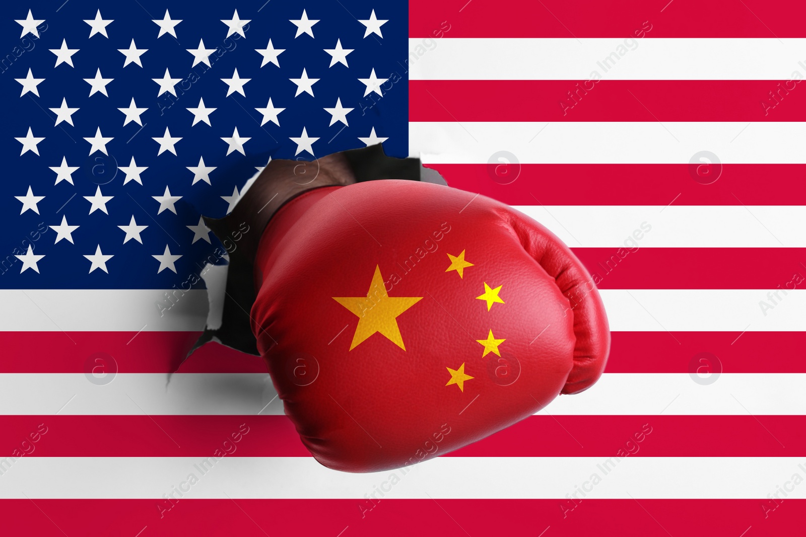 Image of Man in boxing glove with Chinese flag punching hole through American flag, closeup. Trade war