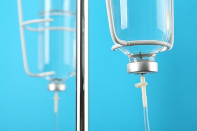 IV infusion set on light blue background, closeup view