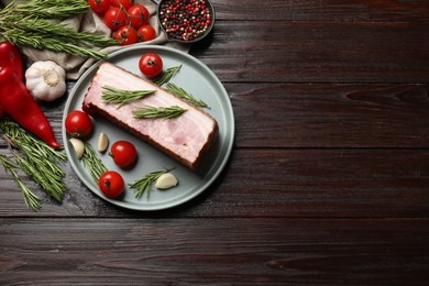 Photo of Piece of raw bacon with spices and cherry tomatoes on wooden table, flat lay. Space for text