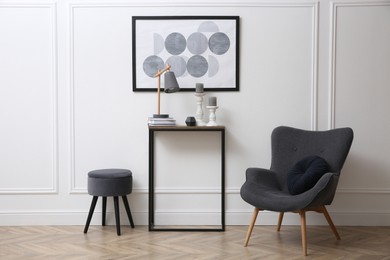 Hallway with stylish console table and armchair. Interior design