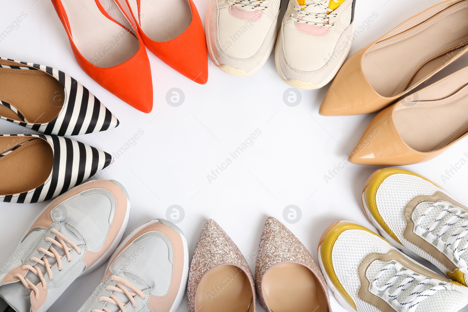 Photo of Frame of different shoes on white background, top view with space for text