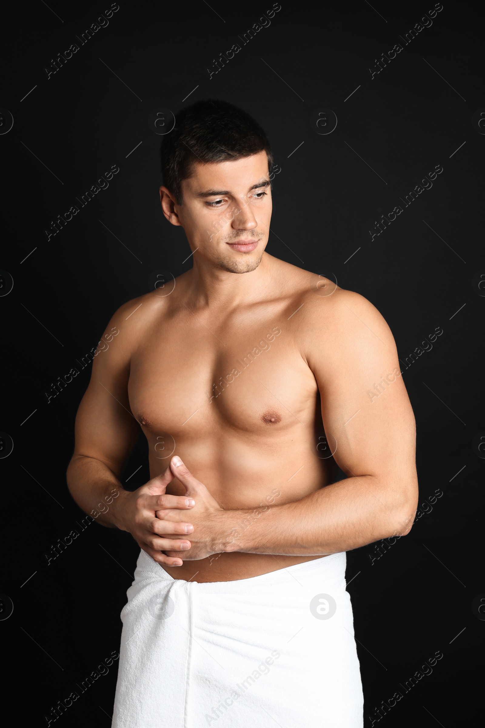 Photo of Man with sexy body on black background