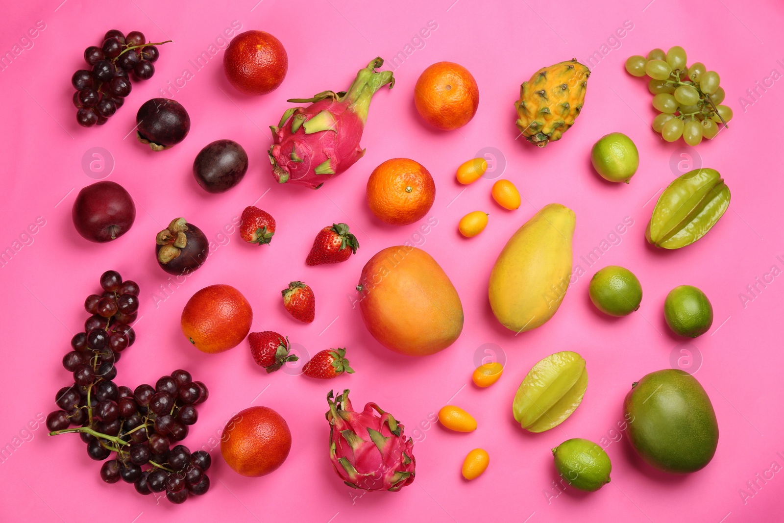 Photo of Many different delicious exotic fruits on pink background, flat lay