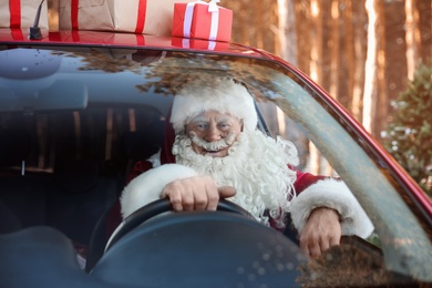 Authentic Santa Claus in car, view through windshield