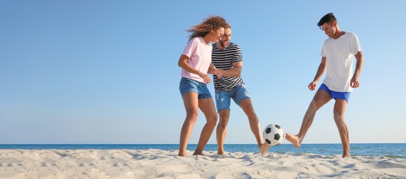 Image of Group of friends playing football on sandy beach, space for text. Banner design