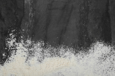 Photo of Flour on grey marble table, top view. Space for text