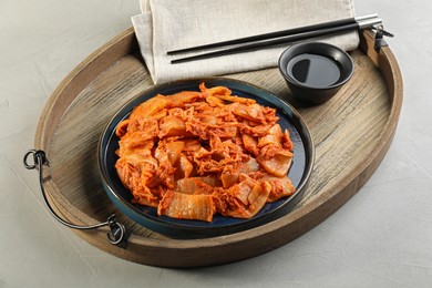 Photo of Delicious kimchi with Chinese cabbage and sauce on white table