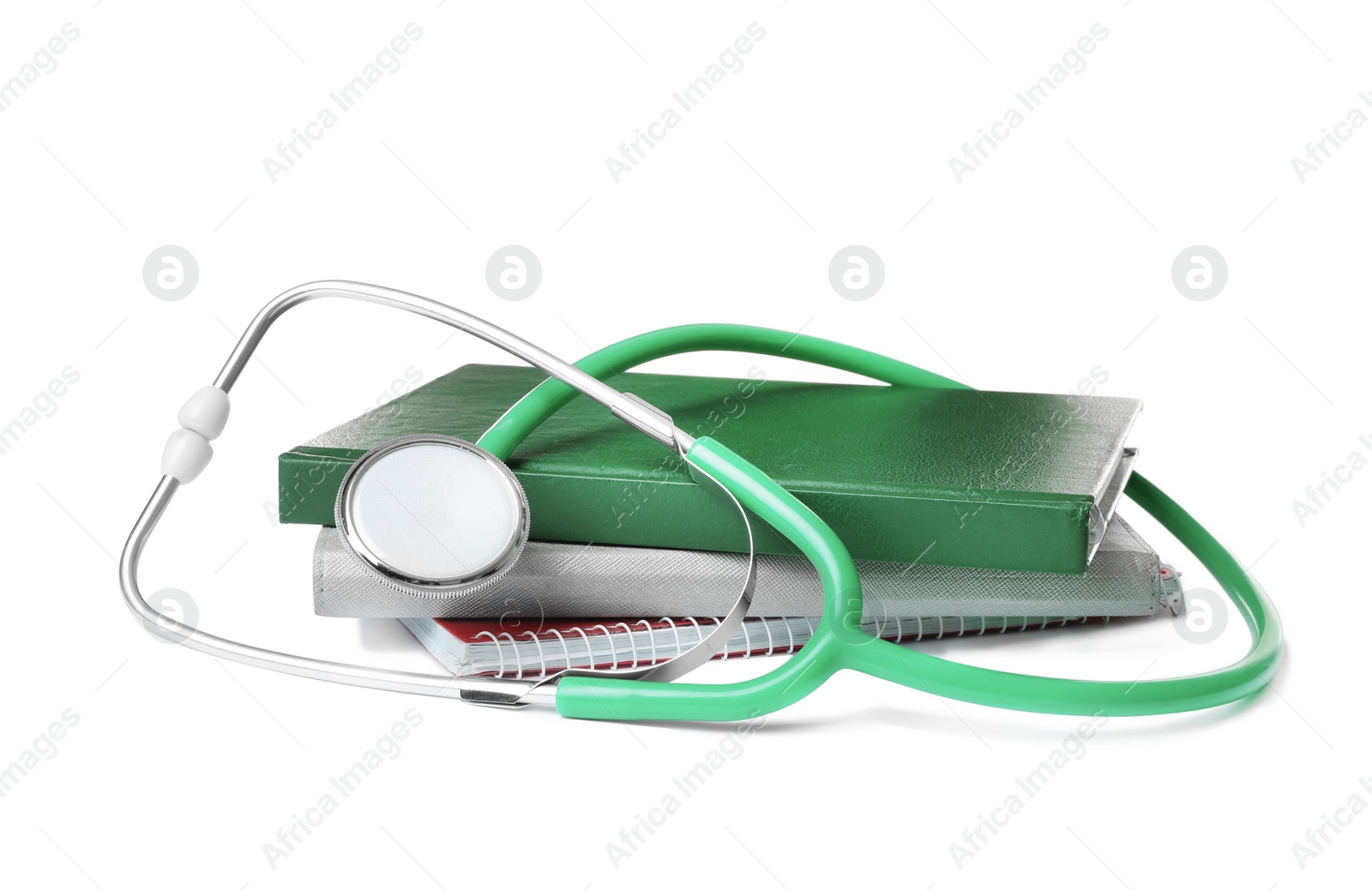 Photo of Stethoscope and notebooks on white background. Medical students stuff