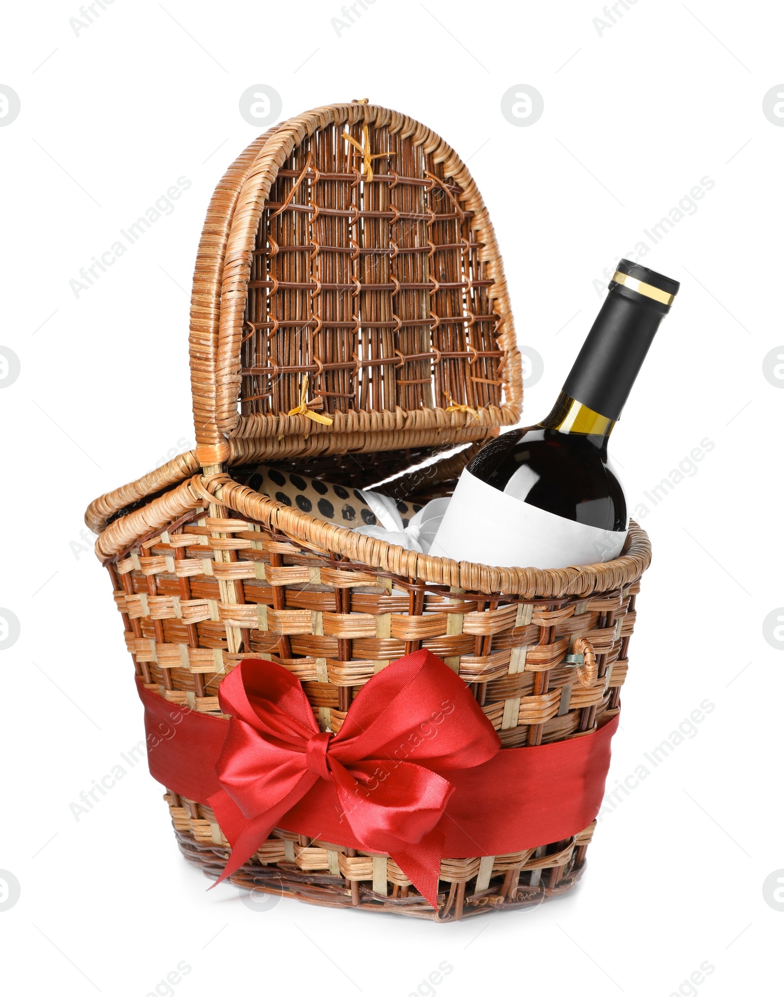 Photo of Festive basket with bottle of wine and gift on white background