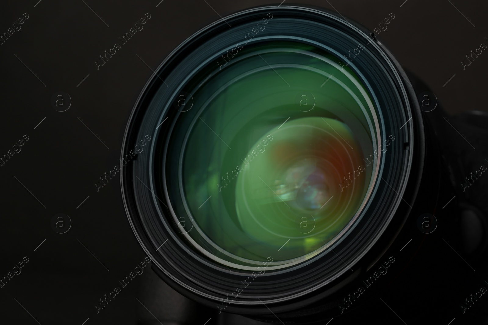 Photo of Lens of professional camera on black background, closeup