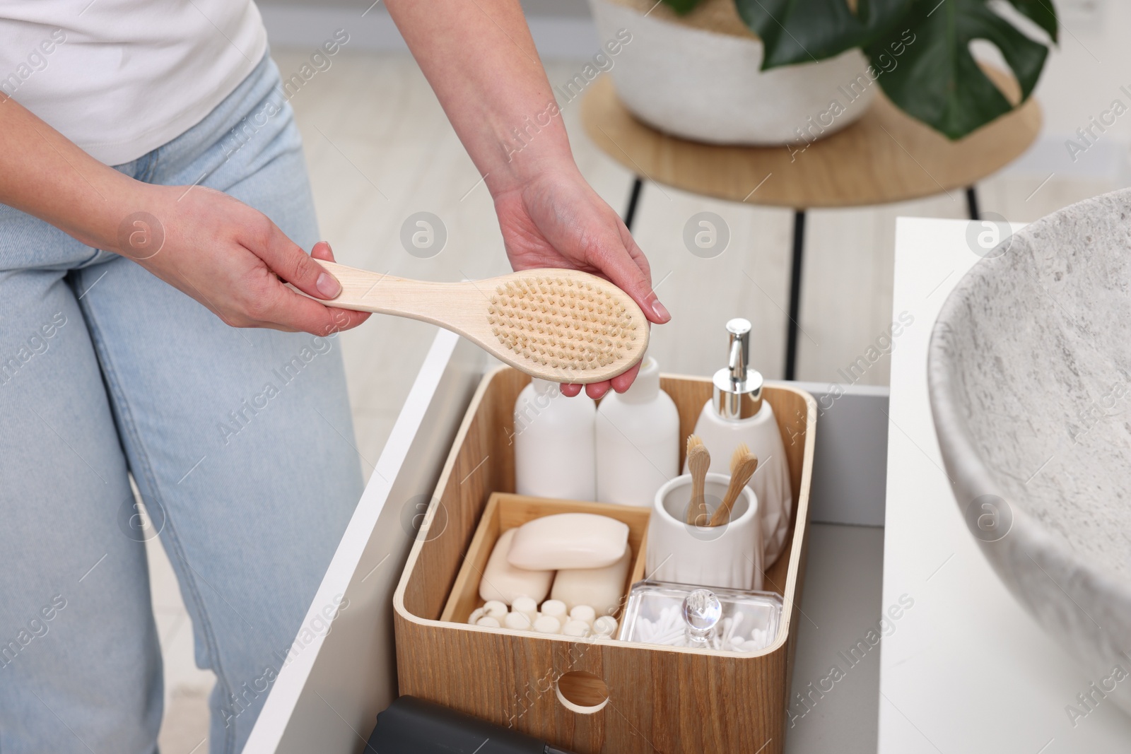 Photo of Bath accessories. Woman organizing personal care products indoors, closeup