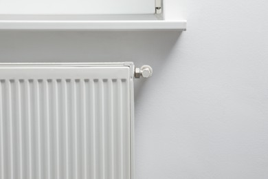 Photo of Closeup view of modern radiator, space for text. Central heating system