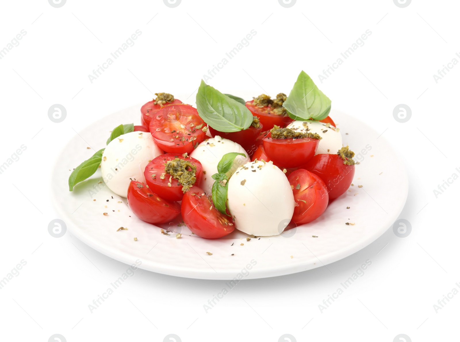 Photo of Plate of tasty salad Caprese with tomatoes, mozzarella balls and basil isolated on white