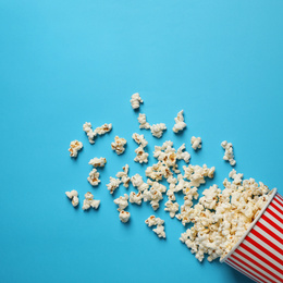 Photo of Delicious popcorn on light blue background, top view