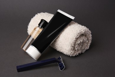 Different men's shaving accessories on grey background, closeup