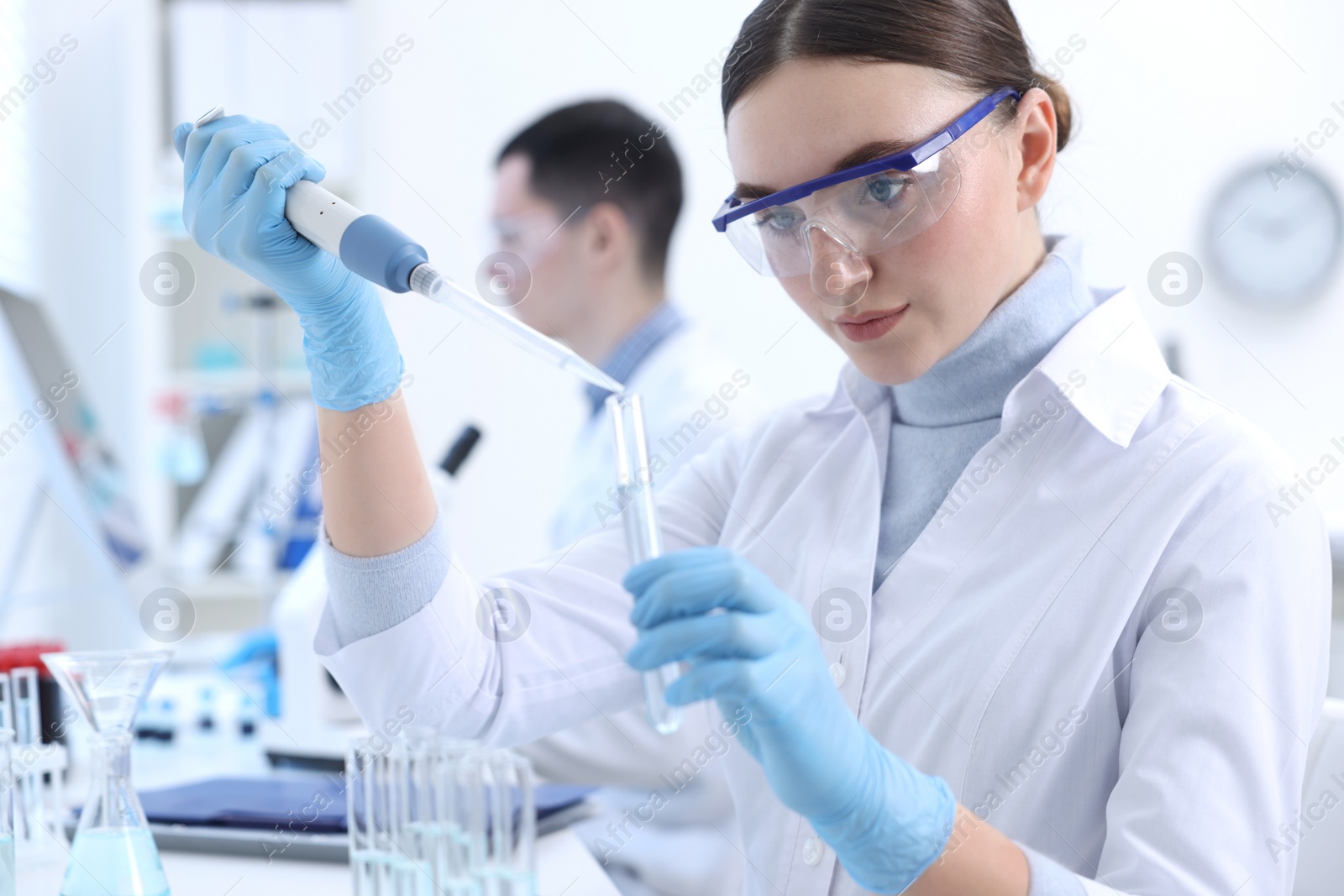 Photo of Scientist dripping sample into test tube in laboratory