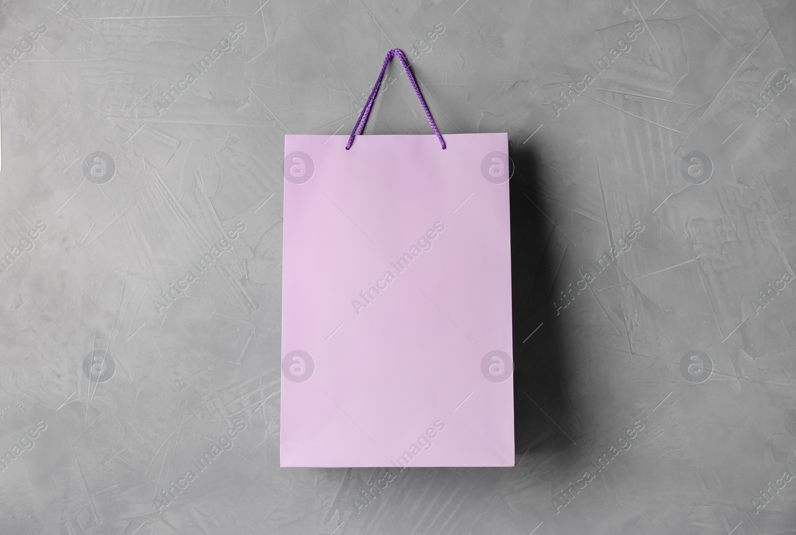 Photo of Paper shopping bag hanging on grey wall