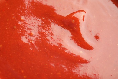Photo of Fresh tasty tomato sauce as background, closeup