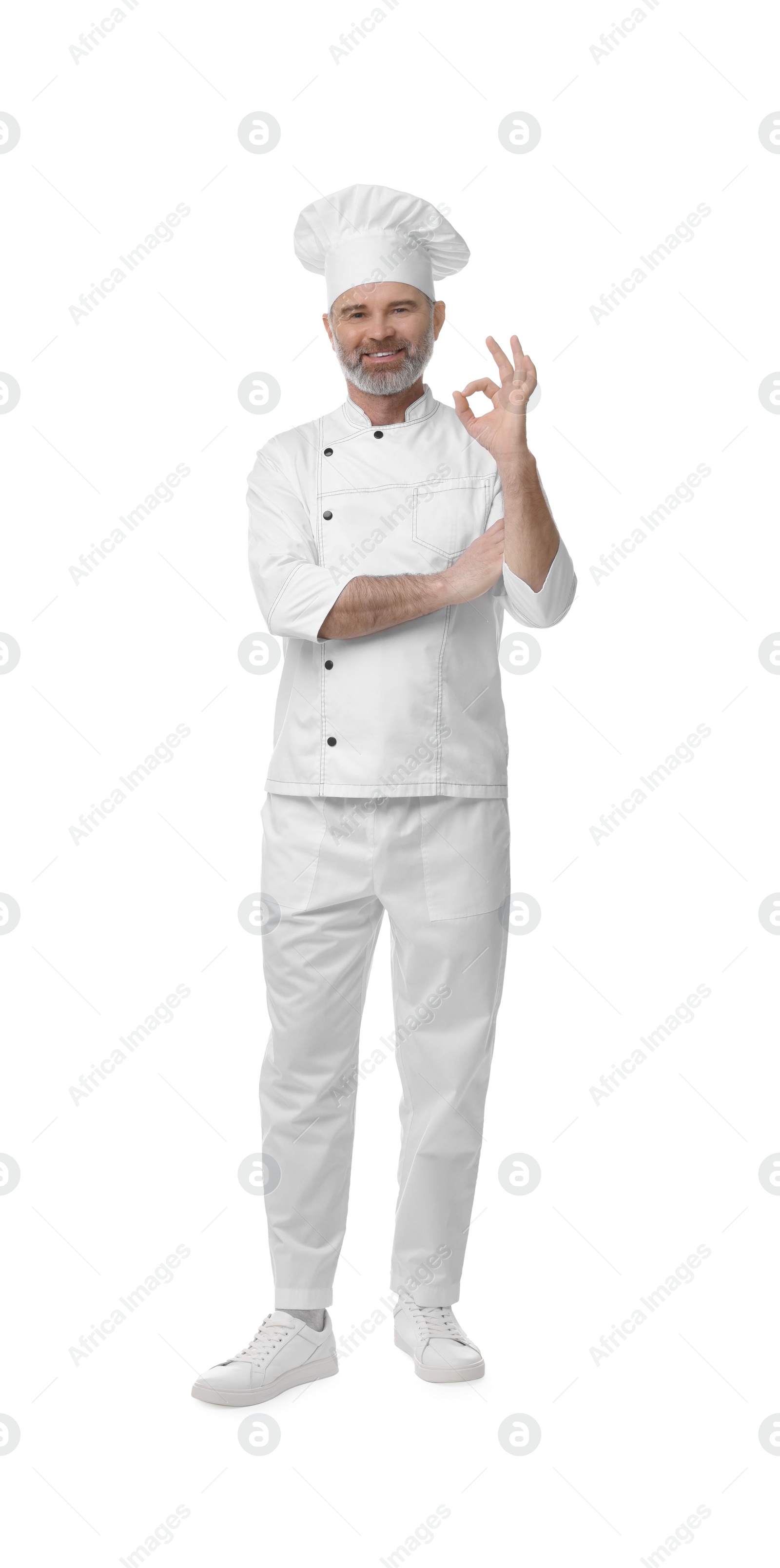 Photo of Happy chef in uniform showing OK gesture on white background