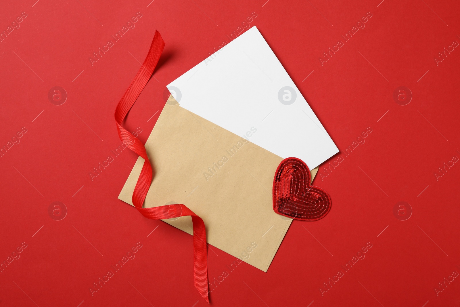 Photo of Blank card, decorative heart and ribbon on red background, flat lay with space for text. Valentine's Day celebration