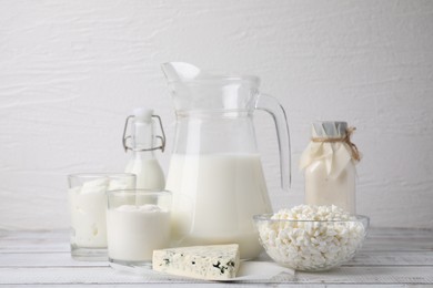 Photo of Different fresh dairy products on white wooden table