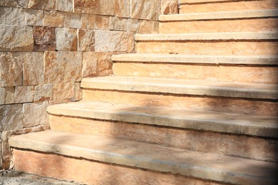 Photo of View of beautiful stone stairs near brick wall outdoors