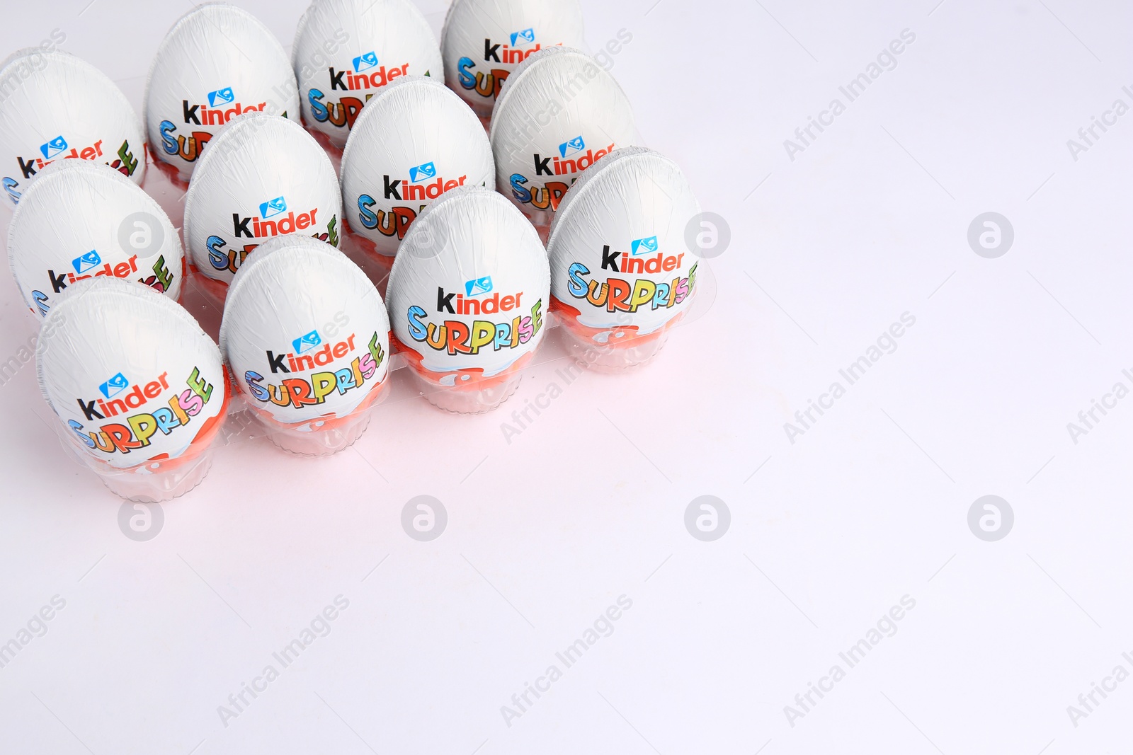 Photo of Sveti Vlas, Bulgaria - June 26, 2023: Kinder Surprise Eggs in plastic tray on white background. Space for text