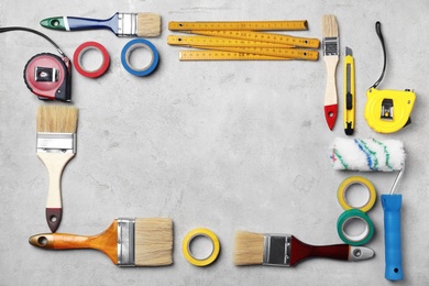 Photo of Set of decorator's tools on grey background, flat lay