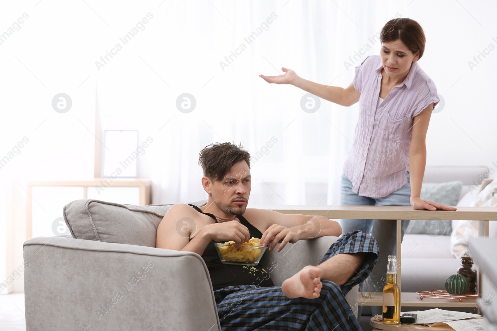 Photo of Lazy husband quarrelling with hardworking wife at home