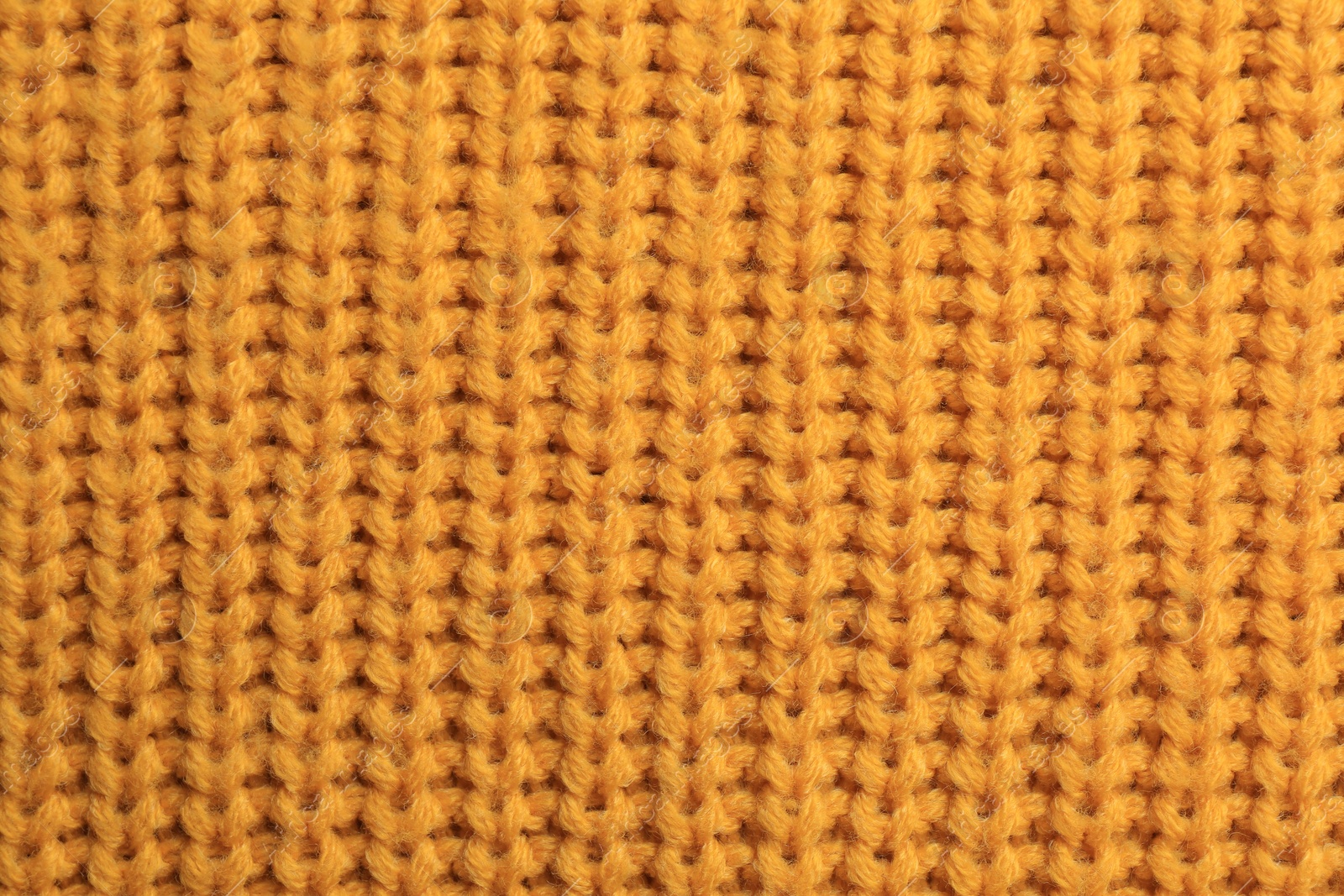 Photo of Beautiful orange knitted fabric as background, top view