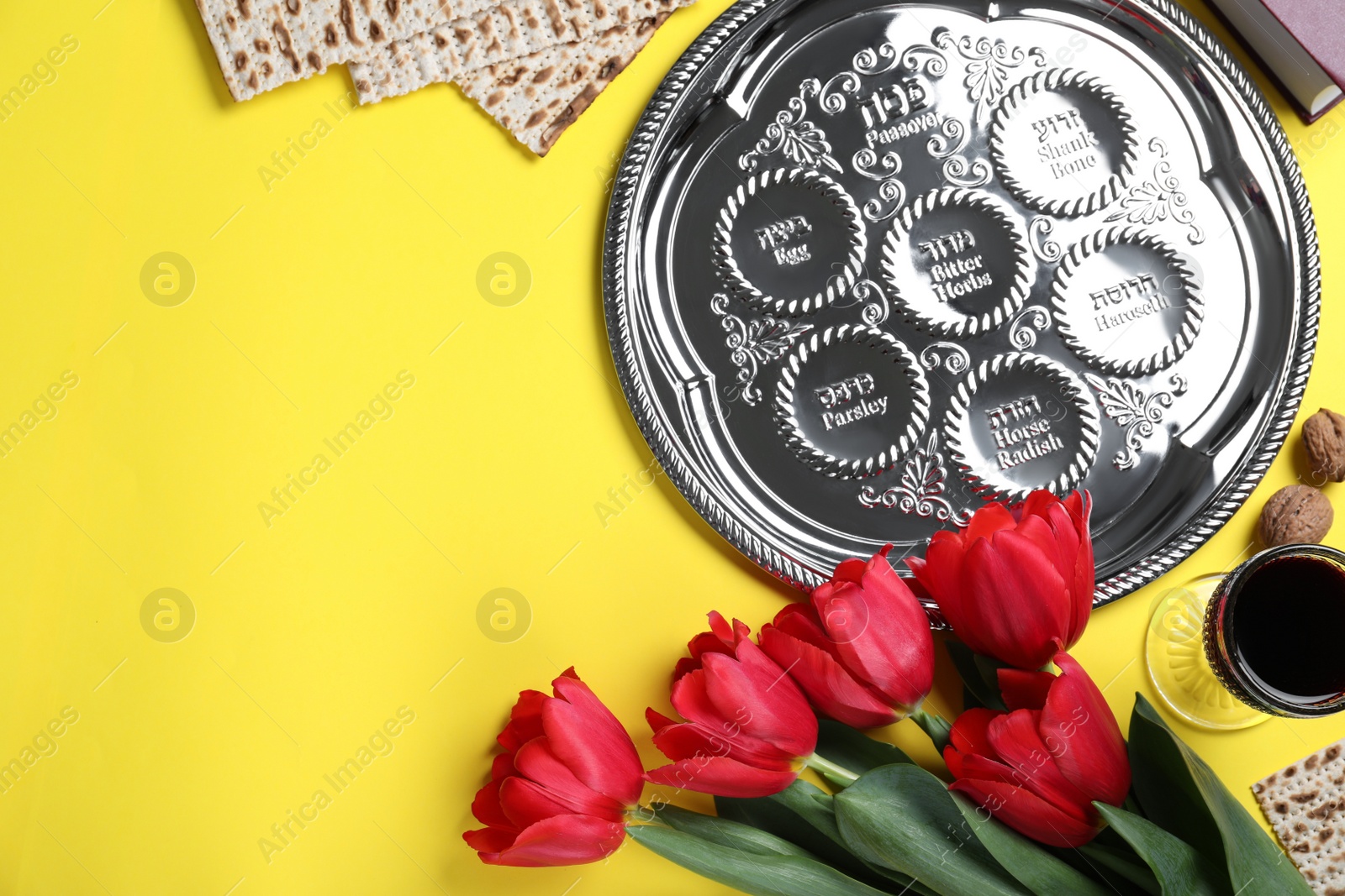 Photo of Flat lay composition with symbolic Pesach (Passover Seder) items on yellow background. Space for text