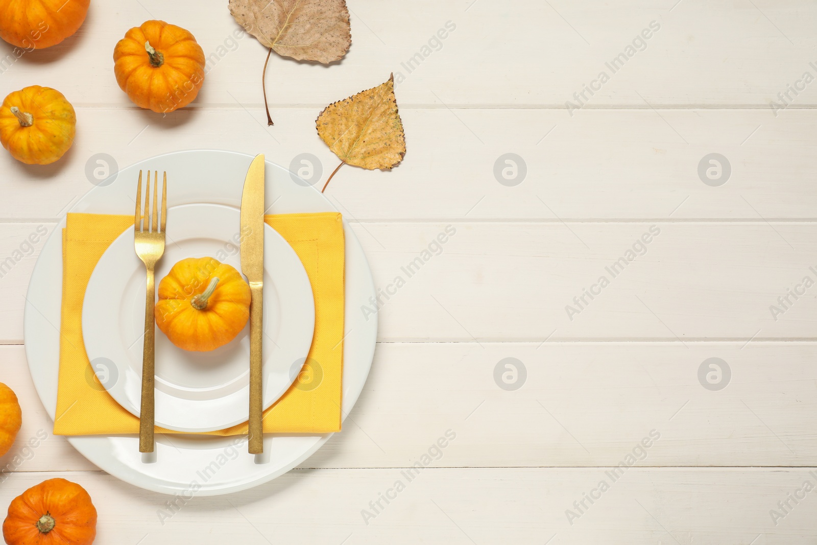 Photo of Stylish autumn table setting on white wooden background, flat lay. Space for text