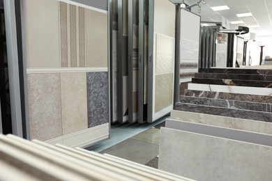 Photo of Assortment of tiles in store. Many different samples indoors