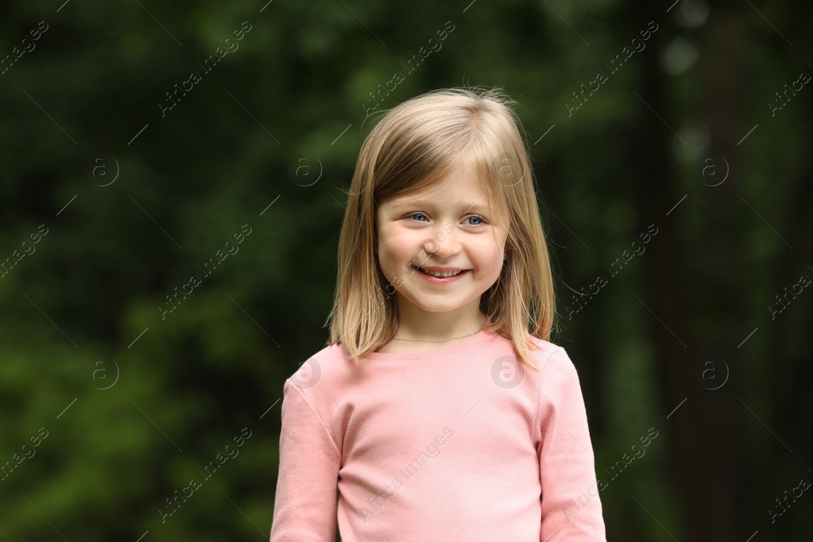 Photo of Portrait of happy cute little girl outdoors