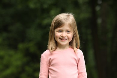 Photo of Portrait of happy cute little girl outdoors