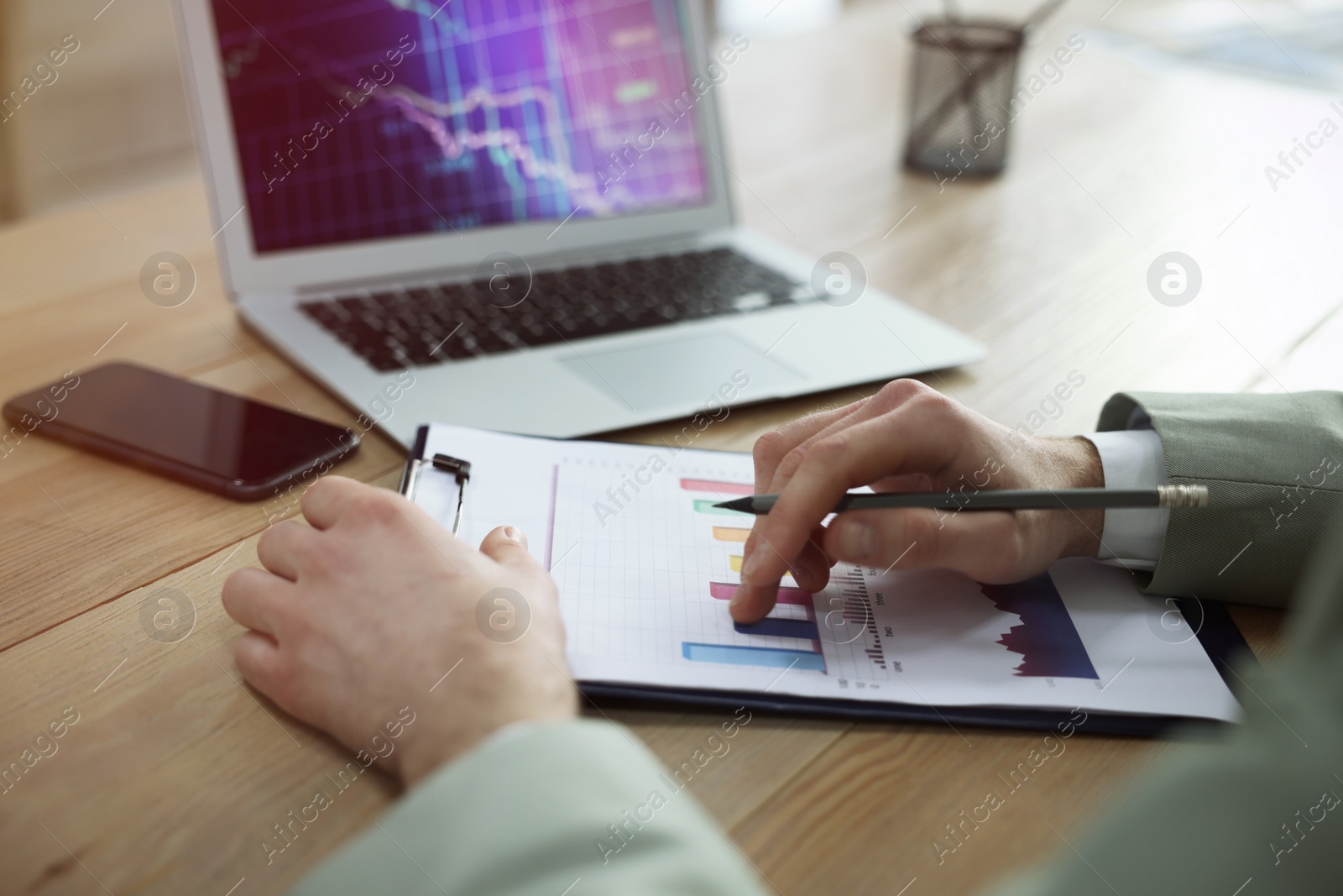 Photo of Forex trader with chart working in office, closeup