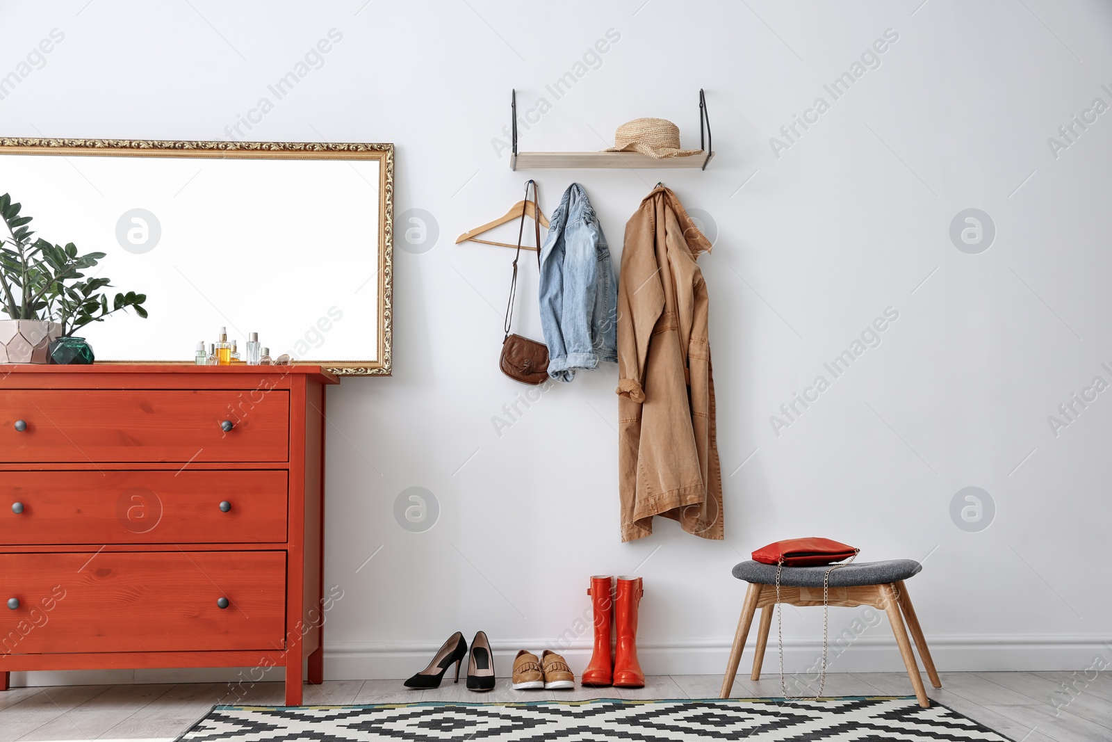 Photo of Stylish hallway interior with mirror and chest of drawers