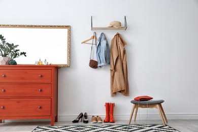 Photo of Stylish hallway interior with mirror and chest of drawers