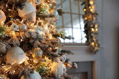 Photo of Closeup view of beautiful decorated Christmas tree indoors