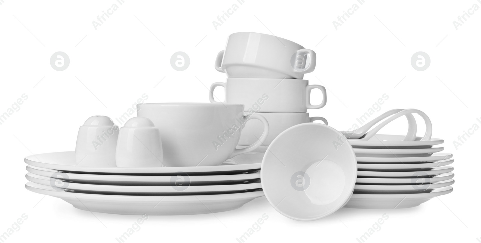 Photo of Set of clean dishware isolated on white