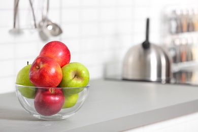 Bowl of fresh apples on kitchen counter. Space for text