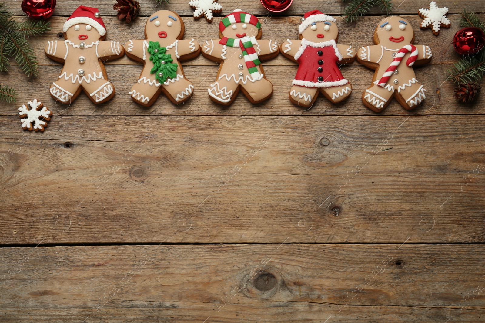 Photo of Delicious Christmas cookies and festive decor on wooden table, flat lay. Space for text