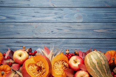 Photo of Flat lay composition with vegetables, fruits and autumn leaves on blue wooden table, space for text. Thanksgiving Day