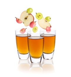 Image of Freshly made apple and grape nectar on white background. Fruits falling into glasses