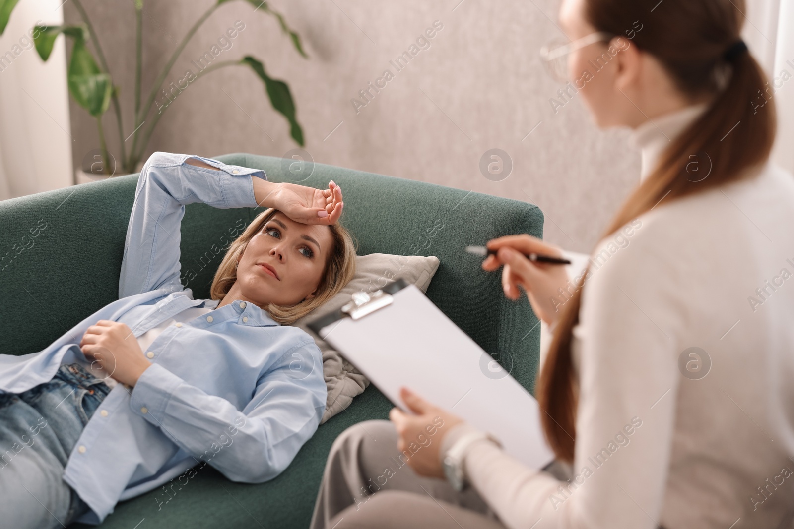 Photo of Professional psychotherapist working with patient in office